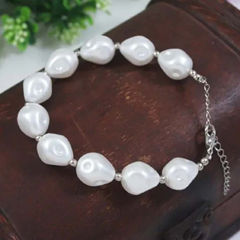 Gold Rodium Polish White and Off White color Bracelet in Brass studded with Pearl