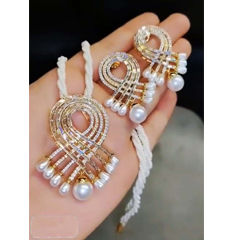 Gold Rodium Polish White and Off White color Pendant in Brass studded with Austrian diamond